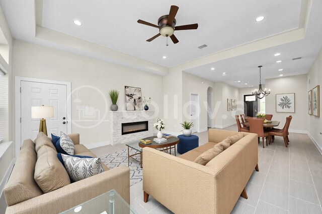 2003 Marthoman Dr, Missouri City, TX 77489 - living area with ceiling fan, arched walkways, a chandelier, a glass covered fireplace, and recessed lighting
