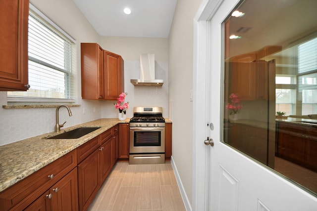 2003 Marthoman Dr, Missouri City, TX 77489 - kitchen featuring wall chimney exhaust hood, stainless steel gas range, a sink, plenty of natural light, and recessed lighting