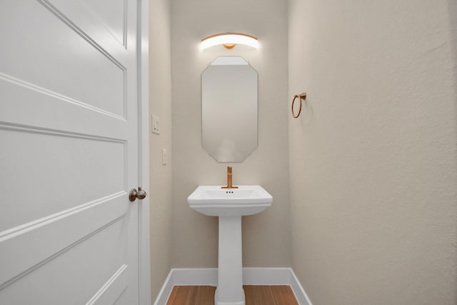 2003 Marthoman Dr, Missouri City, TX 77489 - bathroom featuring baseboards, wood finished floors, and a sink