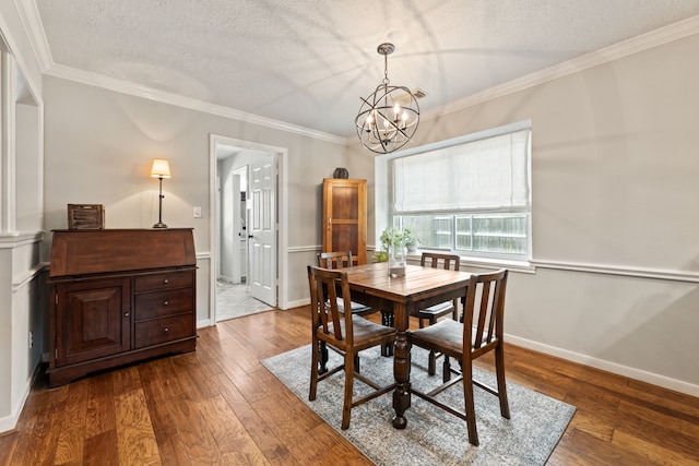 6509 Patricia St, Katy, TX 77493 - dining room with a chandelier, hardwood / wood-style floors, crown molding, a textured ceiling, and baseboards