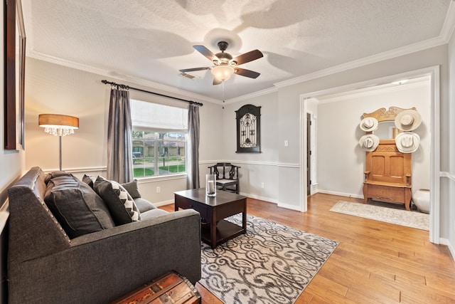 6509 Patricia St, Katy, TX 77493 - living area with a ceiling fan, light wood-style floors, crown molding, and a textured ceiling