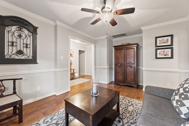 6509 Patricia St, Katy, TX 77493 - living area featuring wood finished floors, ceiling fan, ornamental molding, and baseboards