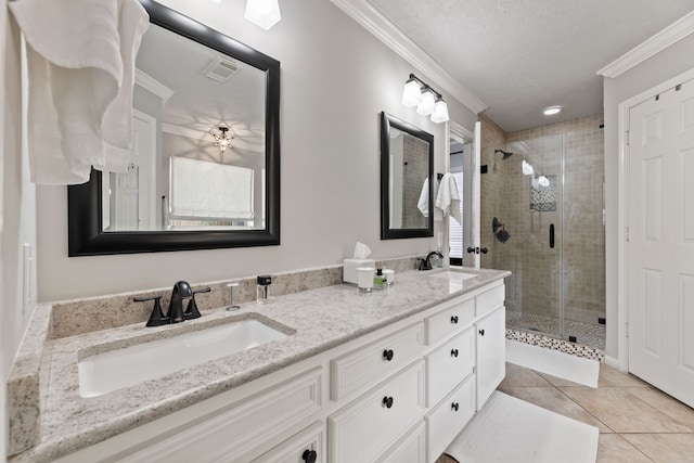 6509 Patricia St, Katy, TX 77493 - full bathroom with a shower stall, double vanity, crown molding, tile patterned flooring, and a textured ceiling