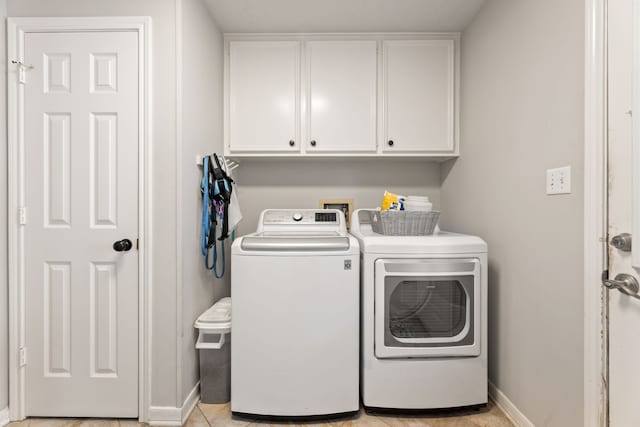 6509 Patricia St, Katy, TX 77493 - laundry room with independent washer and dryer, cabinet space, baseboards, and light tile patterned floors