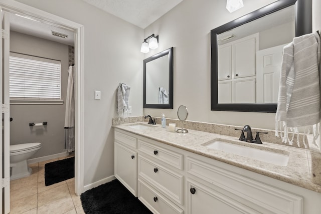 6509 Patricia St, Katy, TX 77493 - bathroom with double vanity, toilet, tile patterned flooring, baseboards, and curtained shower