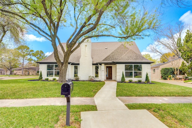 1810 Eagle Falls Ct, Houston, TX 77077 - view of front of house featuring roof with shingles, a front yard, a chimney, and brick siding
