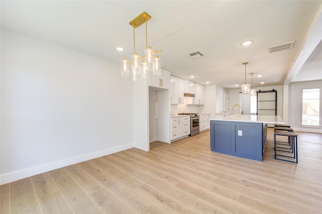 1810 Eagle Falls Ct, Houston, TX 77077 - kitchen with high end stove, a chandelier, a sink, light wood-type flooring, and recessed lighting