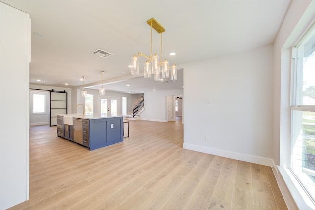 1810 Eagle Falls Ct, Houston, TX 77077 - kitchen featuring open floor plan, a barn door, light countertops, recessed lighting, and light wood-style flooring