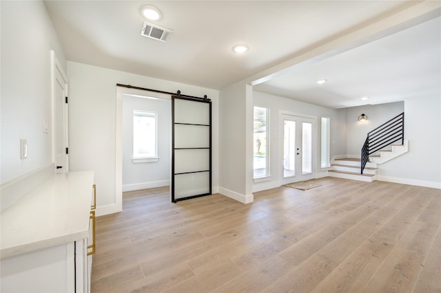 1810 Eagle Falls Ct, Houston, TX 77077 - entryway featuring stairway, light wood-style floors, a barn door, baseboards, and recessed lighting