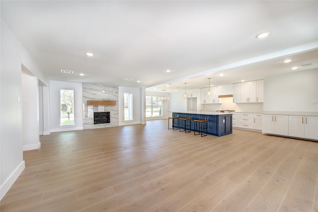 1810 Eagle Falls Ct, Houston, TX 77077 - unfurnished living room with recessed lighting, light wood finished floors, baseboards, and a stone fireplace