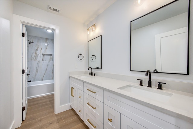 1810 Eagle Falls Ct, Houston, TX 77077 - full bath featuring double vanity, wood finished floors, baseboards, and bathtub / shower combination