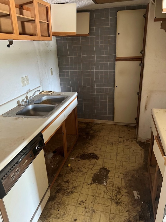 7402 Alabonson Rd Unit 202, Houston, TX 77088 - kitchen with white dishwasher, a sink, tile patterned floors, and light countertops