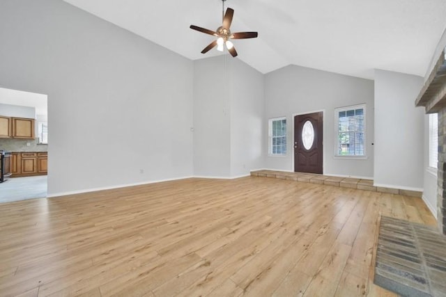 1223 Berrystone Trl, Missouri City, TX 77459 - foyer with high vaulted ceiling, light wood-style floors, a ceiling fan, and baseboards