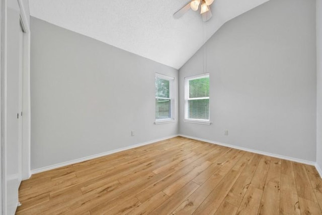 1223 Berrystone Trl, Missouri City, TX 77459 - spare room featuring ceiling fan, light wood-type flooring, vaulted ceiling, and baseboards