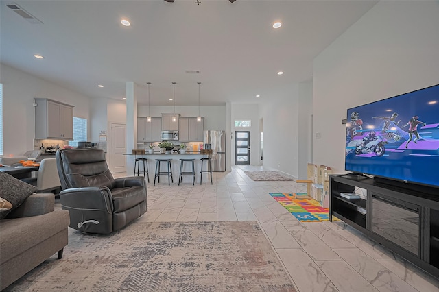 4507 Mustang Run Dr, Rosenberg, TX 77469 - living area featuring light marble finish flooring and recessed lighting
