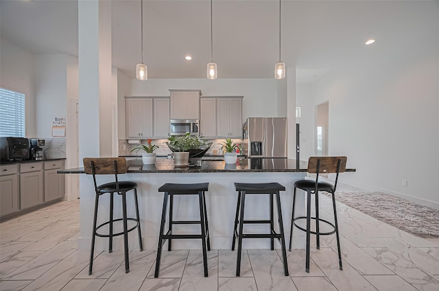 4507 Mustang Run Dr, Rosenberg, TX 77469 - kitchen featuring appliances with stainless steel finishes, gray cabinetry, a kitchen bar, tasteful backsplash, and light marble finish flooring