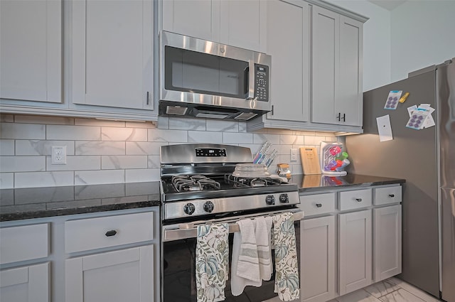 4507 Mustang Run Dr, Rosenberg, TX 77469 - kitchen with stainless steel appliances, dark stone countertops, backsplash, and light marble finish flooring