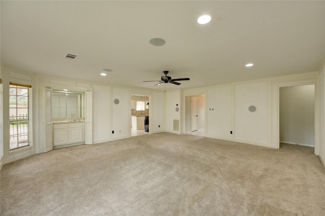 1802 Cobblestone Ct, Richmond, TX 77406 - unfurnished living room featuring a ceiling fan, light carpet, a sink, and recessed lighting