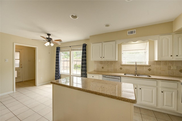 1802 Cobblestone Ct, Richmond, TX 77406 - kitchen featuring a sink, stainless steel dishwasher, light tile patterned floors, light stone countertops, and tasteful backsplash