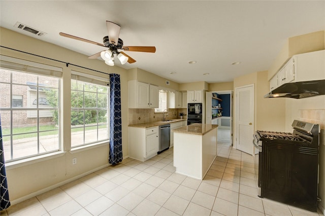 1802 Cobblestone Ct, Richmond, TX 77406 - kitchen featuring black appliances, under cabinet range hood, a sink, white cabinetry, and ceiling fan