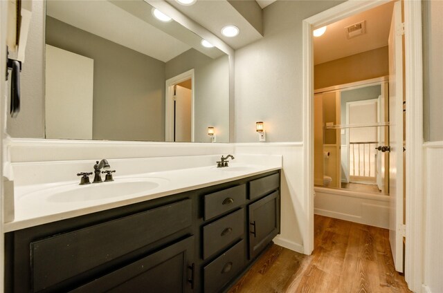 1802 Cobblestone Ct, Richmond, TX 77406 - bathroom featuring toilet, double vanity, and wood finished floors