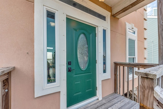 247 Isles End Rd, Tiki Island, TX 77554 - view of exterior entry with stucco siding