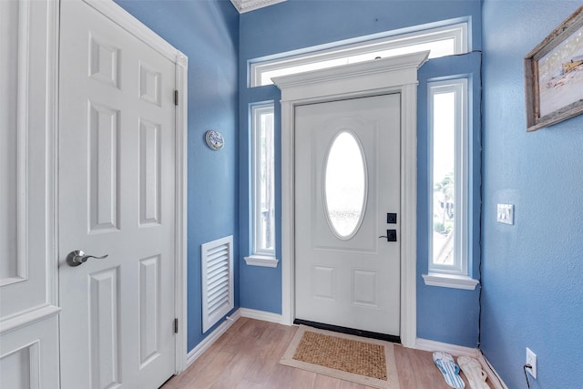 247 Isles End Rd, Tiki Island, TX 77554 - foyer featuring baseboards, light wood-style floors, and a textured wall