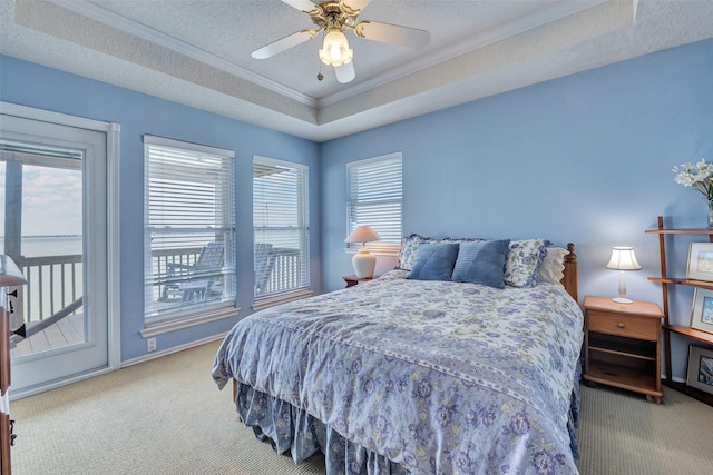 247 Isles End Rd, Tiki Island, TX 77554 - bedroom with carpet, access to outside, ornamental molding, a tray ceiling, and ceiling fan
