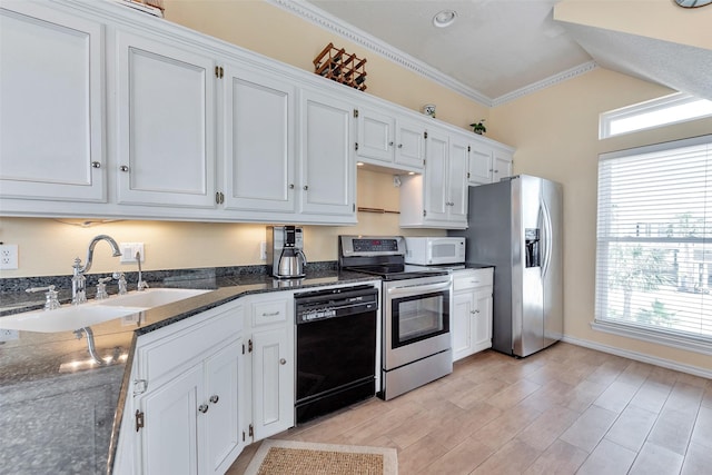 247 Isles End Rd, Tiki Island, TX 77554 - kitchen with appliances with stainless steel finishes, a sink, ornamental molding, white cabinets, and dark stone countertops