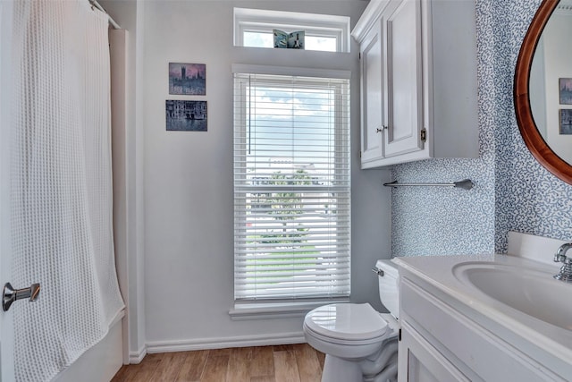 247 Isles End Rd, Tiki Island, TX 77554 - bathroom with wood finished floors, toilet, curtained shower, vanity, and healthy amount of natural light
