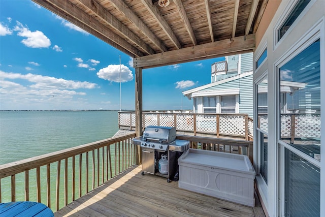 247 Isles End Rd, Tiki Island, TX 77554 - wooden terrace with a grill, a water view, and a yard