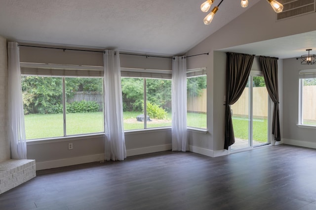1204 Osborne Dr, Friendswood, TX 77546 - empty room featuring vaulted ceiling, baseboards, wood finished floors, and a chandelier