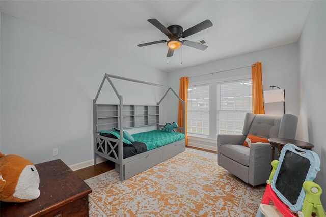810 Stubbs St, La Marque, TX 77568 - bedroom featuring wood finished floors, baseboards, and a ceiling fan