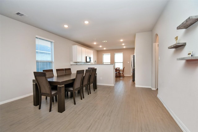 7419 French Quarter Ct, Fulshear, TX 77441 - dining room with light wood-style flooring, baseboards, recessed lighting, and arched walkways