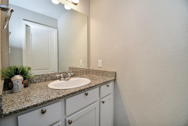 7419 French Quarter Ct, Fulshear, TX 77441 - bathroom with vanity and a textured wall