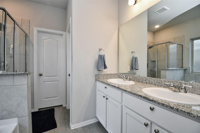 7419 French Quarter Ct, Fulshear, TX 77441 - bathroom featuring a shower stall, double vanity, and baseboards