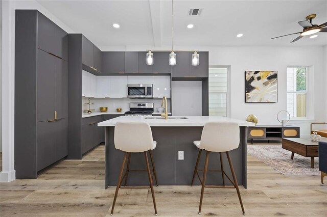 1805 Emir St Unit D, Houston, TX 77009 - kitchen featuring a sink, stainless steel appliances, modern cabinets, light countertops, and recessed lighting