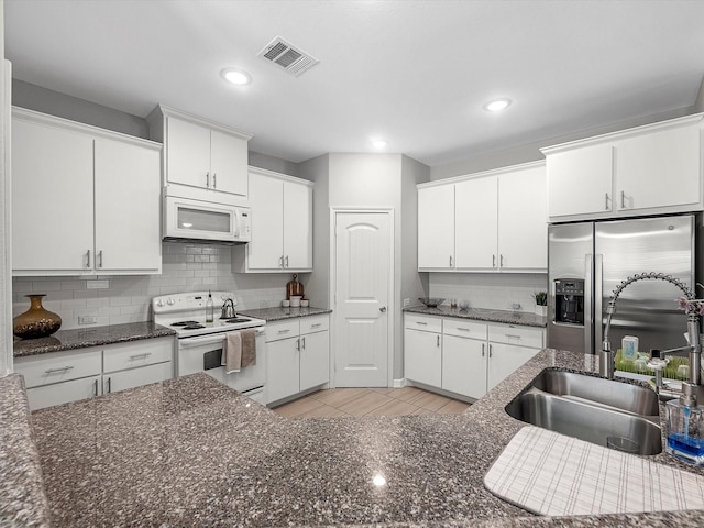 7718 Duncan St, Houston, TX 77093 - kitchen with white appliances, a sink, decorative backsplash, white cabinetry, and recessed lighting