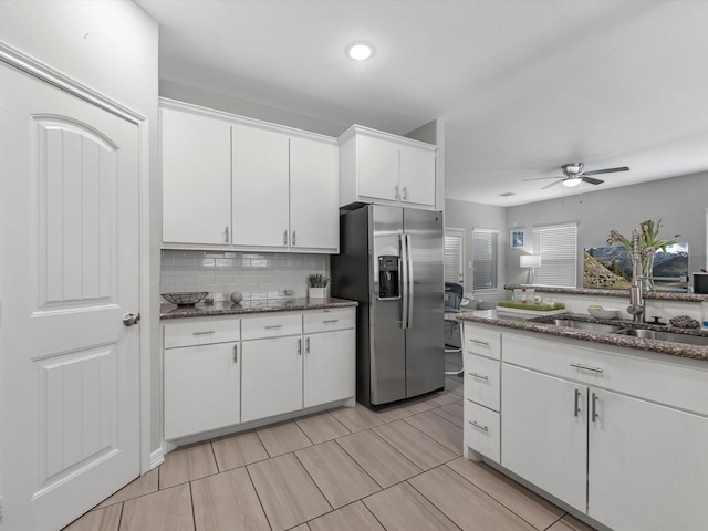 7718 Duncan St, Houston, TX 77093 - kitchen with stainless steel fridge with ice dispenser, a sink, white cabinets, ceiling fan, and backsplash