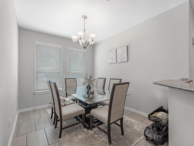 7718 Duncan St, Houston, TX 77093 - dining area featuring a chandelier and baseboards