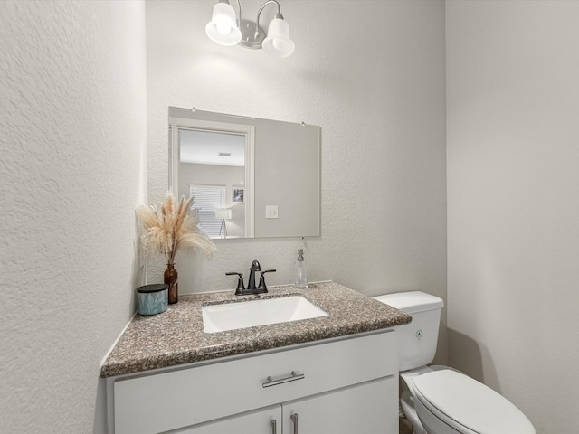 7718 Duncan St, Houston, TX 77093 - half bathroom with vanity, a chandelier, a textured wall, and toilet