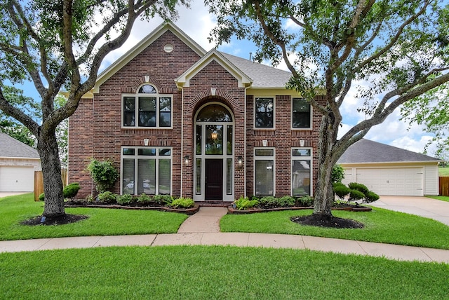 3911 Fielder Cir, Missouri City, TX 77459 - view of front facade with brick siding, concrete driveway, a front yard, and a garage
