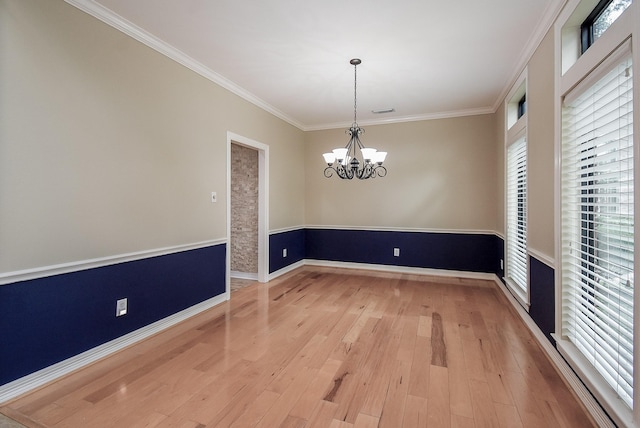3911 Fielder Cir, Missouri City, TX 77459 - unfurnished dining area featuring wood finished floors, crown molding, a chandelier, and baseboards