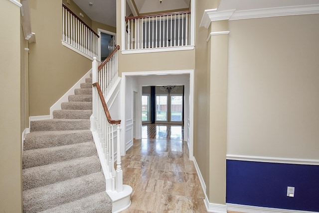 3911 Fielder Cir, Missouri City, TX 77459 - entryway with stairs, wood finished floors, crown molding, baseboards, and a towering ceiling