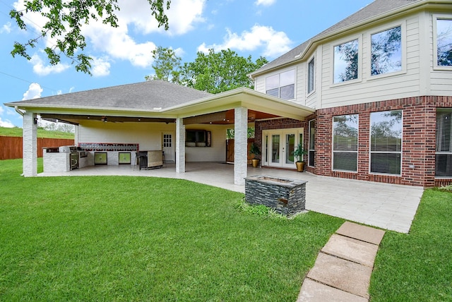3911 Fielder Cir, Missouri City, TX 77459 - back of property with area for grilling, french doors, brick siding, a patio, and a shingled roof