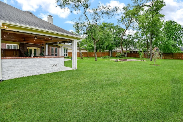 3911 Fielder Cir, Missouri City, TX 77459 - view of yard with a ceiling fan, a patio, french doors, and a fire pit