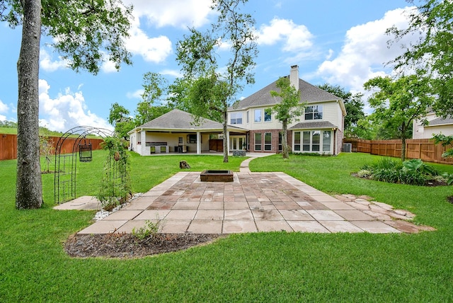 3911 Fielder Cir, Missouri City, TX 77459 - back of house featuring a patio area, a chimney, an outdoor fire pit, brick siding, and central AC unit