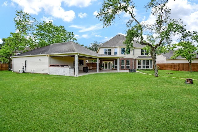 3911 Fielder Cir, Missouri City, TX 77459 - back of property with a patio area, brick siding, and a shingled roof