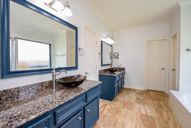 3911 Fielder Cir, Missouri City, TX 77459 - bathroom featuring ornamental molding, two vanities, and a bathtub