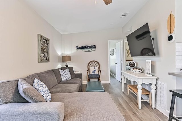 4126 Reeves Dr, Galveston, TX 77554 - living room featuring wood finished floors, ceiling fan, and baseboards